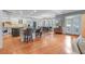 Spacious kitchen with a center island, white cabinetry, hardwood floors, stainless appliances, and a breakfast nook at 5040 Harrington Rd, Johns Creek, GA 30022