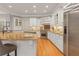 Spacious kitchen with granite countertops, stainless steel appliances, and custom white cabinetry at 5040 Harrington Rd, Johns Creek, GA 30022