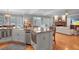 Open concept kitchen with stainless steel appliances and views of the living room and outdoor scenery at 5040 Harrington Rd, Johns Creek, GA 30022