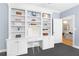 Stylish office with built-in shelving and cabinets, providing ample storage and workspace at 5040 Harrington Rd, Johns Creek, GA 30022