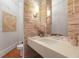 Stylish powder room featuring a modern floating vanity, stone accent wall, and elegant lighting at 5040 Harrington Rd, Johns Creek, GA 30022