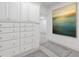 Large storage room with custom built-ins, accent rugs, and neutral decor throughout the space at 5040 Harrington Rd, Johns Creek, GA 30022