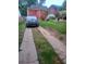 Backyard view includes a long concrete driveway leading to the home and a parked SUV at 1105 Oak Knoll Ter, Atlanta, GA 30315