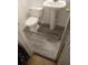 A bathroom with pedestal sink, toilet, and wood-look flooring at 1105 Oak Knoll Ter, Atlanta, GA 30315
