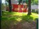 Charming red home with a cozy front porch and lush green lawn at 1105 Oak Knoll Ter, Atlanta, GA 30315