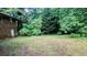 Large backyard featuring mature trees, a brick building and plentiful green space at 2569 Dobbs Nw Dr, Kennesaw, GA 30152