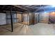 Unfinished basement features an open layout with concrete floor and door to outside at 2569 Dobbs Nw Dr, Kennesaw, GA 30152