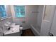 Well-lit bathroom features white tile walls, a new vanity and wood-look floors at 2569 Dobbs Nw Dr, Kennesaw, GA 30152