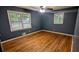 Stylish bedroom with hardwood floors, neutral paint, and ample sunlight at 2569 Dobbs Nw Dr, Kennesaw, GA 30152