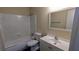 This bathroom features a shower-tub combination, white tiled walls, and a modern sink at 3656 Salem Trl, Lithonia, GA 30038