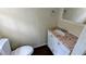 Half bathroom features a white vanity with a stone countertop and wood-look flooring at 3656 Salem Trl, Lithonia, GA 30038
