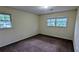 Bedroom featuring carpet, two windows, and neutral walls for a serene living space at 3656 Salem Trl, Lithonia, GA 30038