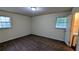 Bedroom featuring two windows, neutral walls, carpet flooring, and access to a bathroom at 3656 Salem Trl, Lithonia, GA 30038