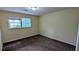 This cozy bedroom features neutral walls, brown carpet, and double-hung windows at 3656 Salem Trl, Lithonia, GA 30038