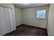 Bedroom features carpet flooring, a double-door closet, a window, and neutral walls at 3656 Salem Trl, Lithonia, GA 30038