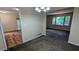 Dining room featuring neutral paint, new carpet and an open concept to the living room at 3656 Salem Trl, Lithonia, GA 30038