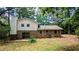 Brick house exterior with patio and wooded backyard at 3656 Salem Trl, Lithonia, GA 30038