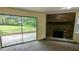 Cozy living room with a brick fireplace and sliding door leading to the outdoor patio at 3656 Salem Trl, Lithonia, GA 30038