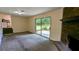 Spacious living room with a brick fireplace and sliding door providing access to the outdoor space at 3656 Salem Trl, Lithonia, GA 30038