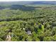 Aerial view of a house surrounded by lush green trees and forest at 4200 E Highway 166 Rd, Carrollton, GA 30116