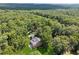 Aerial view of a house surrounded by lush green trees and forest at 4200 E Highway 166 Rd, Carrollton, GA 30116