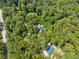 Aerial view of a house surrounded by lush green trees and forest at 4200 E Highway 166 Rd, Carrollton, GA 30116