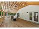 Spacious back porch with vaulted ceilings, outdoor seating, and views of the surrounding trees at 4200 E Highway 166 Rd, Carrollton, GA 30116