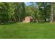 View of a big grassy backyard featuring a shed at 4200 E Highway 166 Rd, Carrollton, GA 30116