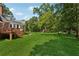 Spacious backyard features a wooden deck, patio, and expansive lawn bordered by mature trees at 4200 E Highway 166 Rd, Carrollton, GA 30116