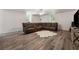 Open basement area featuring hardwood flooring, a sectional couch, and a TV at 4200 E Highway 166 Rd, Carrollton, GA 30116