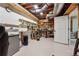Unfinished basement with open ceiling, shelving and work bench at 4200 E Highway 166 Rd, Carrollton, GA 30116
