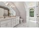 Bathroom featuring double sinks, marble floors, and large arched window at 4200 E Highway 166 Rd, Carrollton, GA 30116