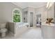 Bright bathroom with tiled floors, a soaking tub, and a separate shower at 4200 E Highway 166 Rd, Carrollton, GA 30116