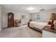 Cozy bedroom with neutral carpet, classic furniture, and soft natural light from a window at 4200 E Highway 166 Rd, Carrollton, GA 30116