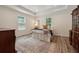 Cozy bedroom featuring wood-look floors, neutral walls, an area rug, and natural light from two windows at 4200 E Highway 166 Rd, Carrollton, GA 30116