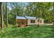 Exterior view of home with porch and blue roof surrounded by lush forest at 4200 E Highway 166 Rd, Carrollton, GA 30116