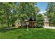 Brick home featuring a welcoming front porch, garage, and a well-maintained yard at 4200 E Highway 166 Rd, Carrollton, GA 30116