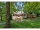 Traditional brick home featuring a spacious front porch and a lush, green lawn at 4200 E Highway 166 Rd, Carrollton, GA 30116