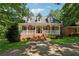Charming brick home with a welcoming front porch and beautifully landscaped front yard at 4200 E Highway 166 Rd, Carrollton, GA 30116