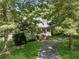 Classic brick home with a large front porch surrounded by mature trees at 4200 E Highway 166 Rd, Carrollton, GA 30116