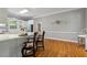 Kitchen with breakfast bar, hardwood floors and views into the next room at 4200 E Highway 166 Rd, Carrollton, GA 30116