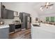Modern kitchen boasts stainless steel appliances, gray cabinets, and a spacious quartz countertop island at 4200 E Highway 166 Rd, Carrollton, GA 30116