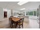 Bright kitchen boasts white cabinets, stainless appliances, light wood floors, and backyard view through a large window at 4200 E Highway 166 Rd, Carrollton, GA 30116