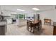 Well-lit kitchen features white cabinets, stainless appliances, gray counters, and adjacent breakfast table at 4200 E Highway 166 Rd, Carrollton, GA 30116