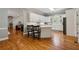 View of the bright kitchen with hardwood floors and white cabinetry at 4200 E Highway 166 Rd, Carrollton, GA 30116