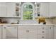 Well-lit kitchen with ample counter space, white cabinets, and modern dishwasher at 4200 E Highway 166 Rd, Carrollton, GA 30116