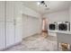 Spacious laundry room has tiled floors, overhead lighting, and plentiful storage cabinets at 4200 E Highway 166 Rd, Carrollton, GA 30116