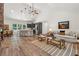 Open-concept living room with a stone fireplace, kitchen island, and casual dining area at 4200 E Highway 166 Rd, Carrollton, GA 30116
