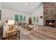 Bright living room features a stone fireplace, hardwood floors and access to the outdoors at 4200 E Highway 166 Rd, Carrollton, GA 30116