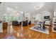 Open-concept living room features hardwood floors, a fireplace, and large windows for plenty of natural light at 4200 E Highway 166 Rd, Carrollton, GA 30116